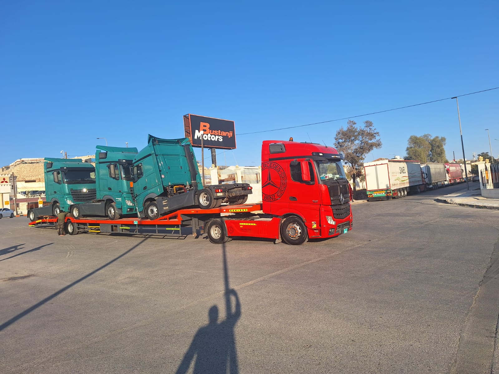 Red Truck Hauling Teal Trucks